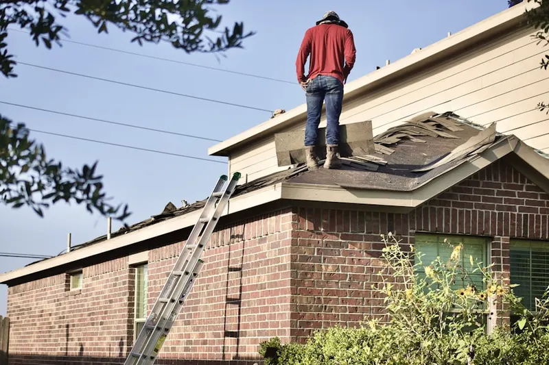 Professional roofer working on a residential roof in Campton